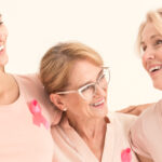 Women laughing and wearing pink in breast cancer support group